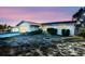 Ranch-style house with a flat roof, light-colored exterior, and a small front yard at 7714 Jasmine Blvd, Port Richey, FL 34668