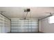 Garage with automatic door and shelving at 7714 Jasmine Blvd, Port Richey, FL 34668