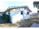 Exterior view of a single story house with light colored siding and a grassy yard at 7714 Jasmine Blvd, Port Richey, FL 34668