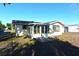 Back of house with sunroom and large windows at 7714 Jasmine Blvd, Port Richey, FL 34668