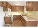 Updated kitchen with wood cabinets, tile floors, and modern appliances at 7714 Jasmine Blvd, Port Richey, FL 34668
