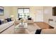 Living room featuring light colored sofas, hardwood floors, and a large window at 7714 Jasmine Blvd, Port Richey, FL 34668