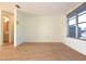 Empty living room with wood-look tile floor and a view of the bathroom at 7714 Jasmine Blvd, Port Richey, FL 34668