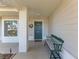 Inviting front porch with a green bench and wreath at 8111 Sugarbush Dr, Spring Hill, FL 34606