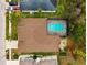 House with a brown roof, pool, and a spacious backyard at 9105 Flagstick Ln, Hudson, FL 34667