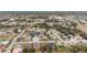 Aerial view showcasing a large neighborhood with houses and swimming pools at 9105 Flagstick Ln, Hudson, FL 34667