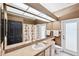 Bathroom with single sink vanity, shower, and exterior access at 9105 Flagstick Ln, Hudson, FL 34667