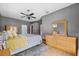 Spacious bedroom with a king-size bed and light wood dresser at 9105 Flagstick Ln, Hudson, FL 34667