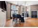 Bright dining area with large windows and a table with four chairs at 9105 Flagstick Ln, Hudson, FL 34667