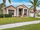 Two-story house with a landscaped lawn and driveway at 9105 Flagstick Ln, Hudson, FL 34667