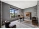 Home office with built-in fireplace and large window at 9105 Flagstick Ln, Hudson, FL 34667