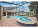 Large screened pool and spa with pavers and a relaxing atmosphere at 9105 Flagstick Ln, Hudson, FL 34667