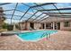 Inviting screened pool and spa with brick pavers at 9105 Flagstick Ln, Hudson, FL 34667