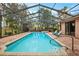 Refreshing screened pool and spa with pavers and lounge chairs at 9105 Flagstick Ln, Hudson, FL 34667