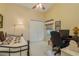 Small bedroom with a twin bed, desk, and office chair at 9639 Conservation Dr, New Port Richey, FL 34655