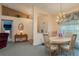 Bright dining room adjacent to entryway with a round table and chairs at 9639 Conservation Dr, New Port Richey, FL 34655