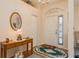 Bright entryway with a wooden console table and an oval mirror at 9639 Conservation Dr, New Port Richey, FL 34655