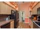 Kitchen features granite countertops, black appliances, and light wood cabinets at 9639 Conservation Dr, New Port Richey, FL 34655