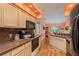 Kitchen with light wood cabinets, granite countertops, and modern appliances at 9639 Conservation Dr, New Port Richey, FL 34655