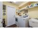 Convenient laundry room with washer, dryer, and utility sink at 9639 Conservation Dr, New Port Richey, FL 34655