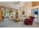 Open living area with vaulted ceilings, comfortable seating, and a view of the dining area at 9639 Conservation Dr, New Port Richey, FL 34655