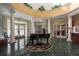 Elegant lobby with a grand piano and marble flooring at 9639 Conservation Dr, New Port Richey, FL 34655