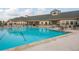 Community pool with spacious deck and clubhouse views at 9639 Conservation Dr, New Port Richey, FL 34655
