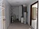 Laundry area with water heater and shelving at 10190 Thayer St, Brooksville, FL 34601