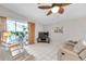 Bright living room with comfy sofas, large TV, and ceiling fan at 10830 Brookhaven Dr, New Port Richey, FL 34654