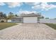 Gray house with white garage door and paved driveway at 11076 Addison St, Spring Hill, FL 34609