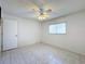 Well-lit bedroom with tiled floors and a ceiling fan at 11310 Palomar St, Spring Hill, FL 34609