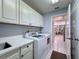 Bright laundry room with washer, dryer, and ample cabinetry at 11310 Palomar St, Spring Hill, FL 34609