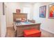 Second bedroom with comfy bed and red bench at 11928 Sand Myrtle Rd, Riverview, FL 33579