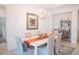 Elegant dining room with a white table, chandelier, and artwork at 11928 Sand Myrtle Rd, Riverview, FL 33579