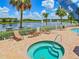 Relaxing spa with lake views and lounge chairs at 12219 Arron Ter, Trinity, FL 34655