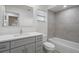 Modern gray bathroom with a bathtub, toilet and vanity at 1355 Powderpuff Dr # 908, Dunedin, FL 34698