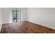 Bedroom with wood-look floors and sliding glass doors at 1355 Powderpuff Dr # 908, Dunedin, FL 34698
