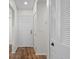 Bright entryway with wood-look floors and white doors at 1355 Powderpuff Dr # 908, Dunedin, FL 34698