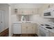 Kitchen with white cabinets, quartz countertops and stainless steel appliances at 1355 Powderpuff Dr # 908, Dunedin, FL 34698