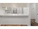 Modern kitchen with white cabinets and quartz countertops at 1355 Powderpuff Dr # 908, Dunedin, FL 34698