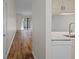 View of kitchen and living area with wood-look floors at 1355 Powderpuff Dr # 908, Dunedin, FL 34698