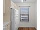 White refrigerator and cabinetry, and a window with blinds at 1355 Powderpuff Dr # 908, Dunedin, FL 34698
