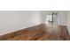 Living room with wood-look floors and access to a patio at 1355 Powderpuff Dr # 908, Dunedin, FL 34698