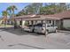 View of community parking lot with carports at 1355 Powderpuff Dr # 908, Dunedin, FL 34698