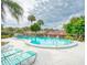 Relaxing kidney-shaped pool with lounge chairs at 1355 Powderpuff Dr # 908, Dunedin, FL 34698