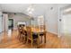 Dining room with hardwood floors and oval wooden table at 1413 Morning Rose Pl, Trinity, FL 34655