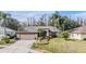 Single-story home with attached garage, landscaping, and driveway at 1413 Morning Rose Pl, Trinity, FL 34655