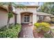 Front entry with double doors and landscaped walkway at 1413 Morning Rose Pl, Trinity, FL 34655