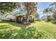Back exterior view showing house, landscaping, and pool at 1413 Morning Rose Pl, Trinity, FL 34655