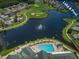 Aerial view of a community pool and lake at 1413 Morning Rose Pl, Trinity, FL 34655